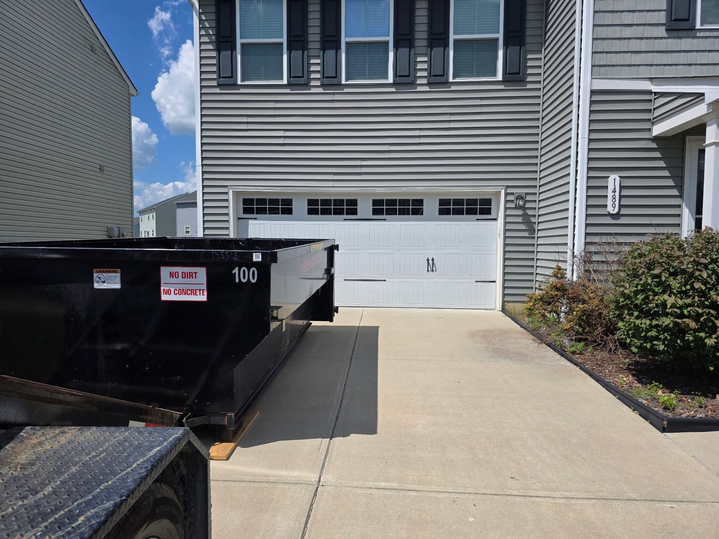 Roll-off container on a residential driveway