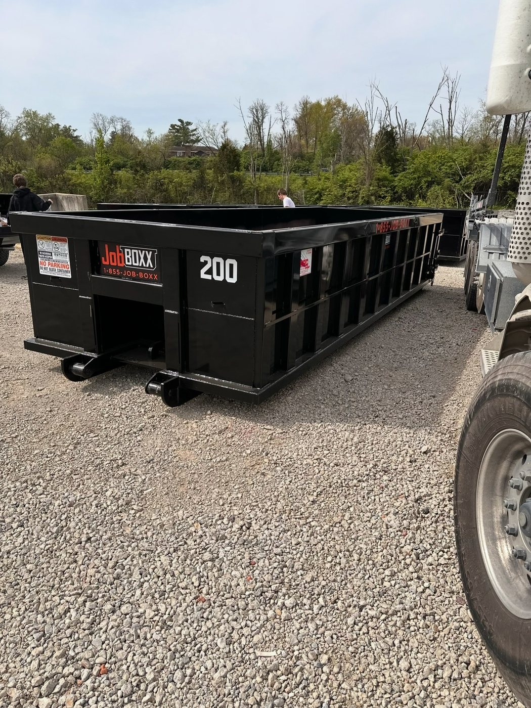 Roll-off container being loaded onto the truck