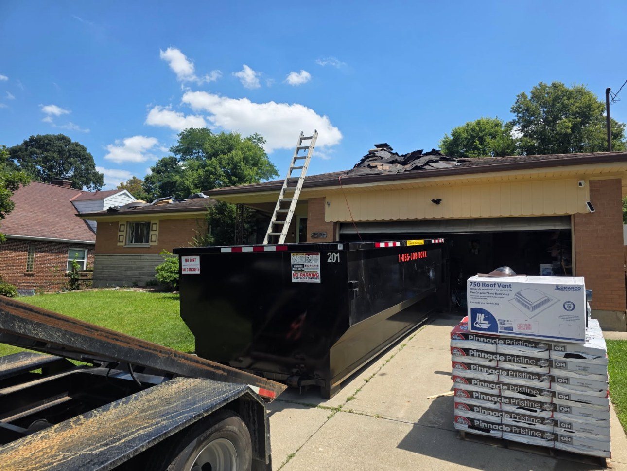 Roll-off container on a roofing job