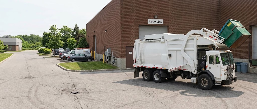 All Waste front load truck emptying a commercial dumpster at a loading dock